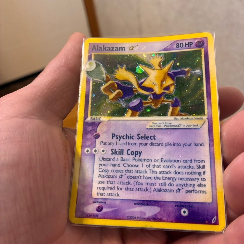 Pokemon Alakazam Card with Purple and Yellow Design